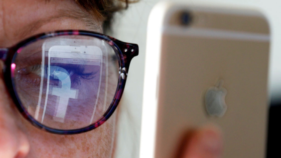 Facebook logo reflected in glasses from phone