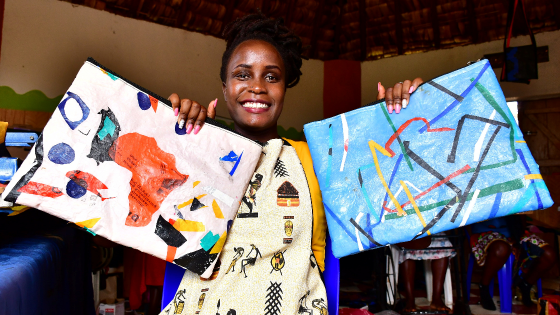 Faith Aweko displays finished hand bags made from transformed polythene waste at the Reform Africa in Social Innovation Academy