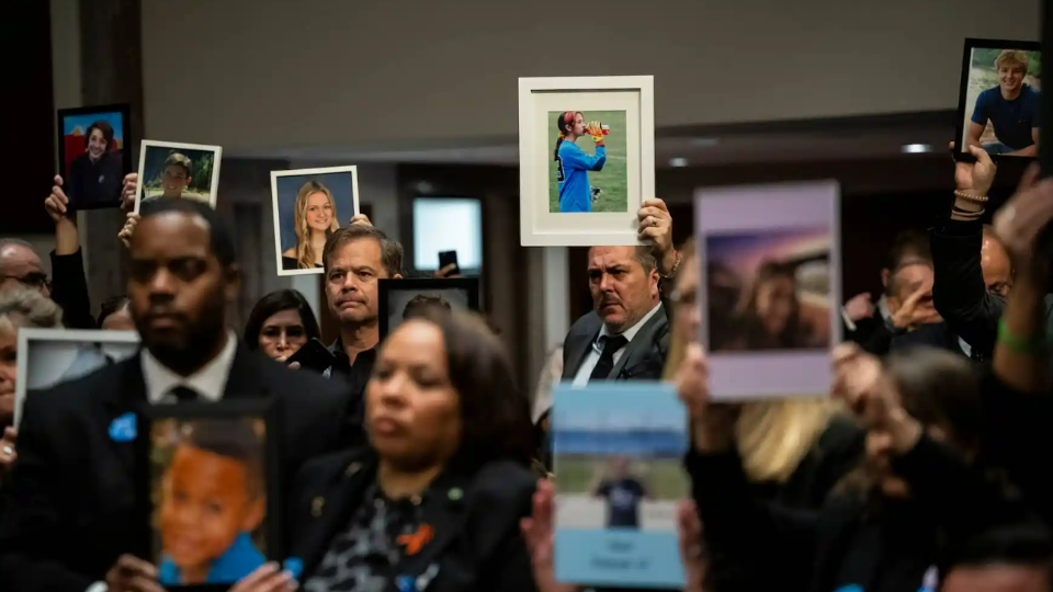 Family members of children who fell victim to dangers on social media hold family photos before a Senate Judiciary Committee hearing