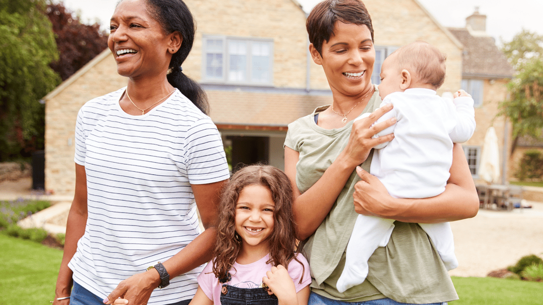 Family of four walking in neighborhood on sunny day