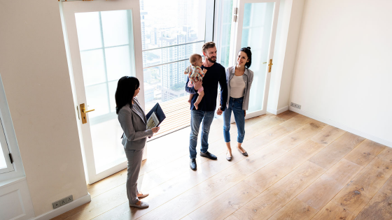 Family touring a house with realtor