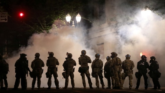 Federal law enforcement officers deployed under the Trump administrations new executive order face off with protesters