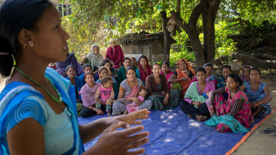 Female community health worker Jharana Kumari Tharu counsels a group of women, including expectant mothers and those who have recently delivered, on good health practices