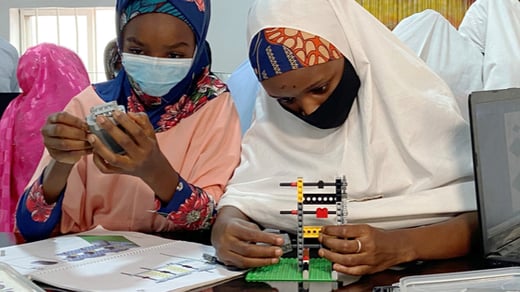 Female students assemble Legos during a robotics STEM learning section of Kabara NGO in Kano, Nigeria
