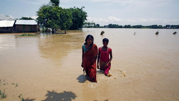 Flood victims walk along the flooded area in Saptari District, Nepal