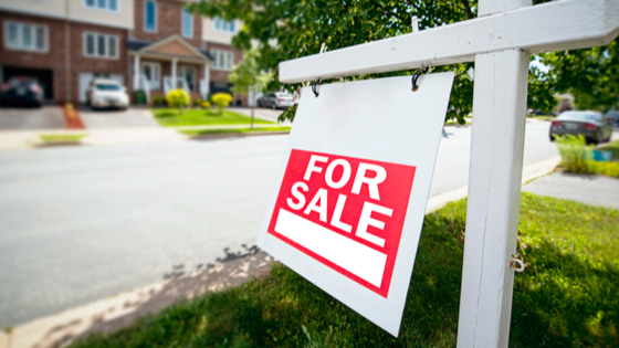 For sale sign in front of a house