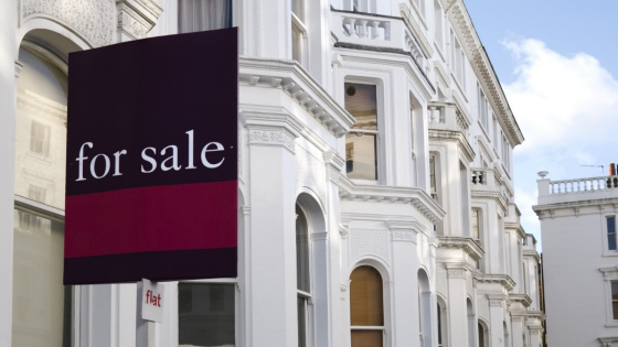 For sale sign outside townhouse property