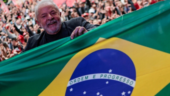 Former Brazilian President and presidential candidate Luiz Inacio Lula da Silva holds a Brazilian flag during a rally