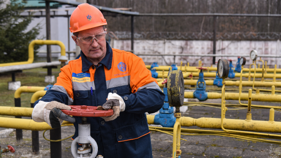 Gas station worker controls gas valve at a natural gas station