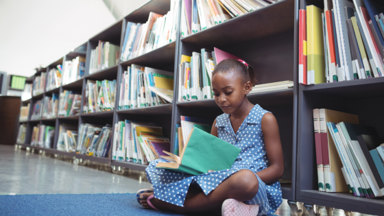 Girl reading alone in a library