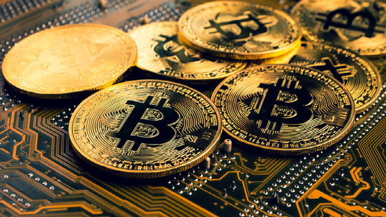 Golden coins with bitcoin symbol on a mainboard