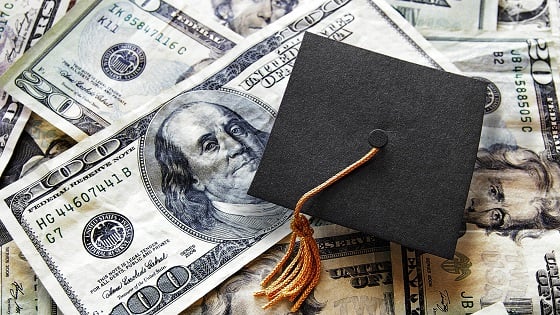 Graduation hat and U.S. dollar bills