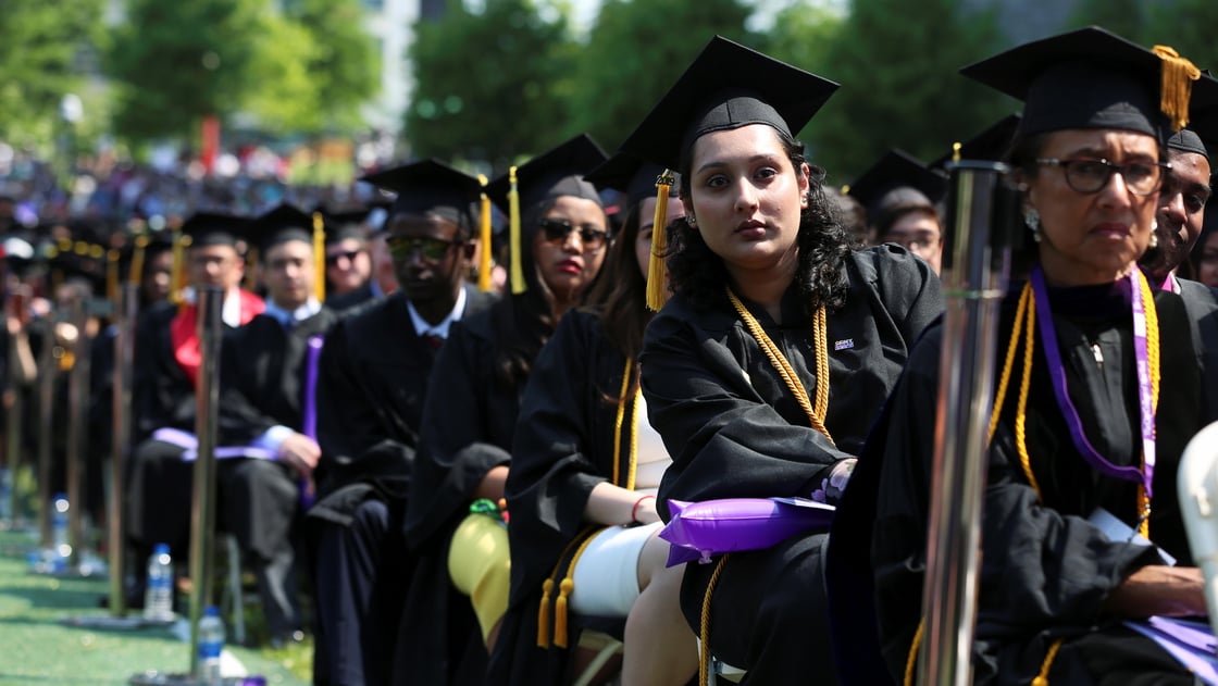 Graduates of The City College of New York sit in their seats at their commencement ceremony in Manhattan