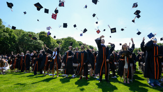 Graduates toss their caps into the air at the conclusion of the Beverly High School class of 2021 graduation ceremony