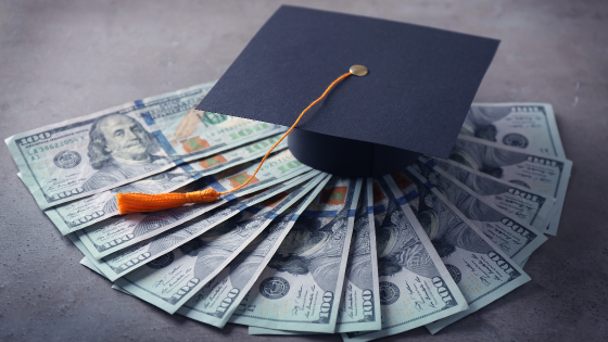 Graduation hat on top of $100 bills