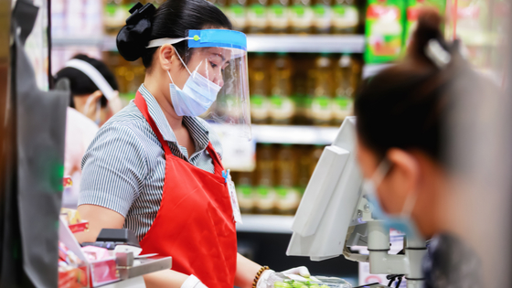 Grocery store worker with face covering