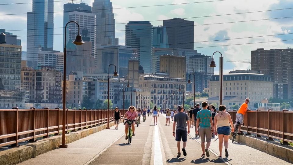 Group of people cross bridge in Minneapolis.