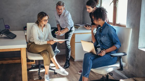 Group of people working together in small office