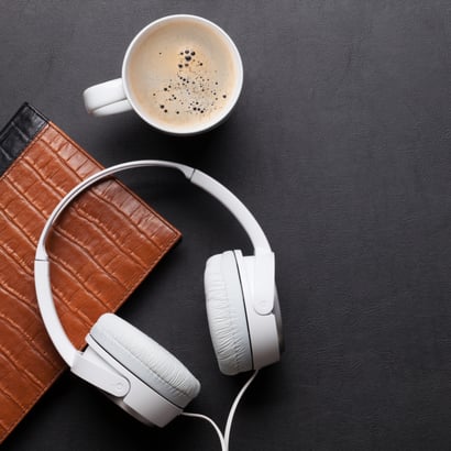 Headphones, notebook, and coffee