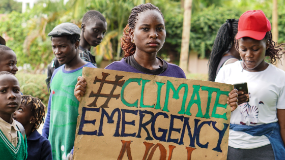 Hilda Flavia Nakabuye holds a sign during the global School Strike for Climate in Kampala