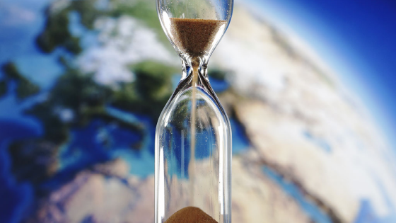 Hourglass with image of Earth in the background