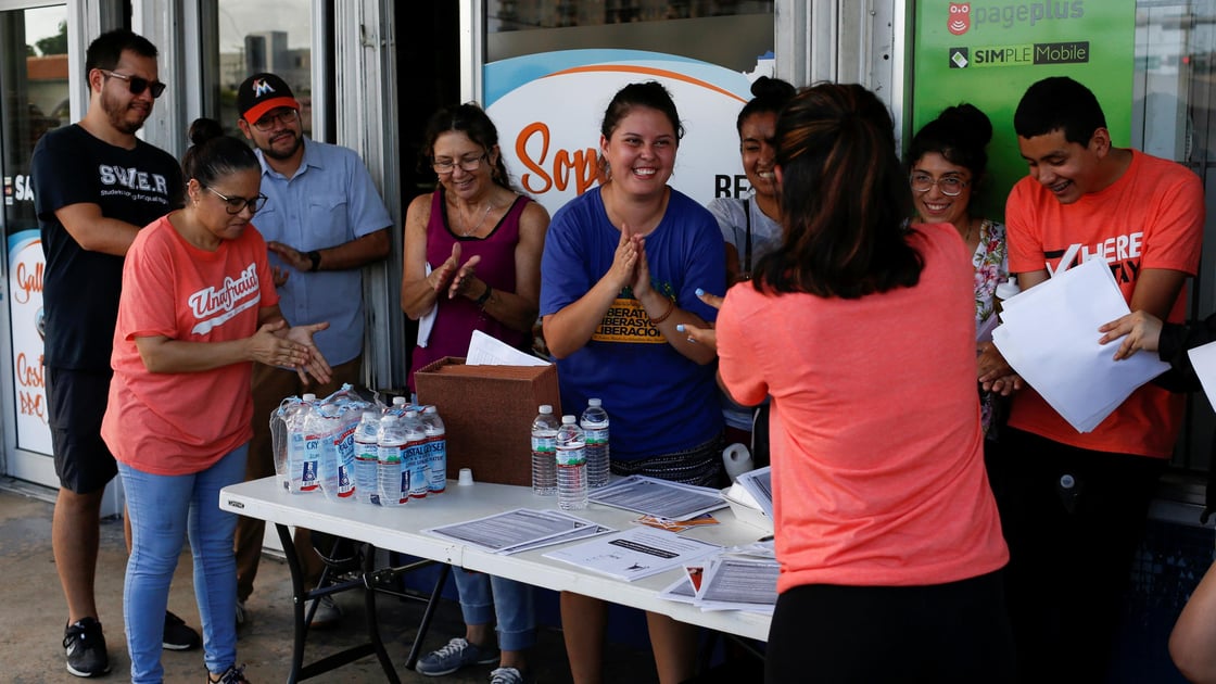 Immigration rights activists meet during a event to hand out pamphlets as communities braced for a reported wave of deportation raids across the United States by ICE