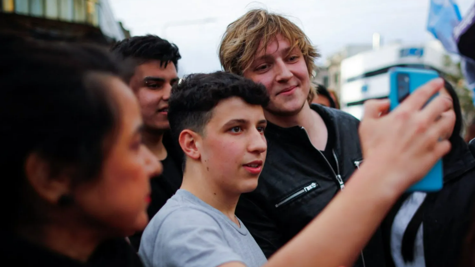 Inaki Gutierrez, who manages Argentine presidential candidate Javier Mileis TikTok, poses for a selfie with a supporter