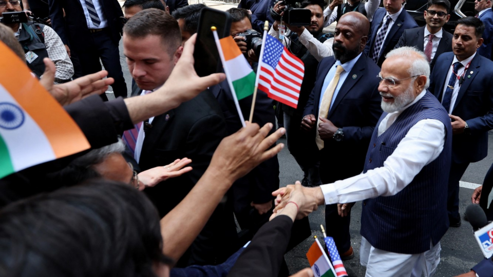 Indian Prime Minister Narendra Modi greets supporters as he arrives at the Lotte hotel in New York City