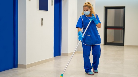 Janitor cleans floor