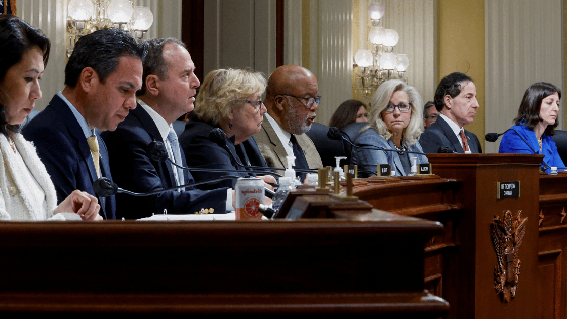 Members of Congress sit in a line at a hearing of the January 6 Committee.