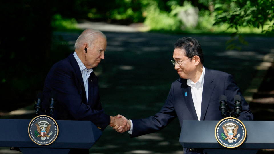 Japanese Prime Minister Fumio Kishida shakes hands with U.S. President Joe Biden during a joint press conference with South Korean President Yoon Suk Yeol 