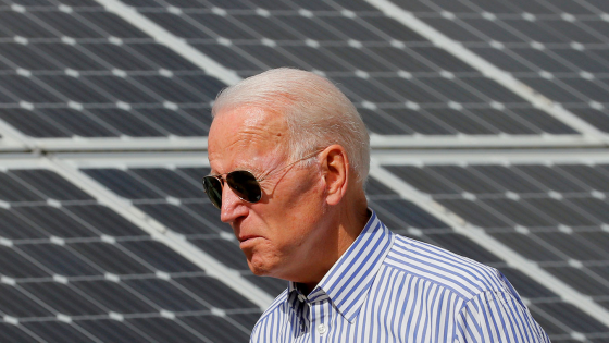 Joe Biden walks past solar panels while touring the Plymouth Area Renewable Energy Initiative in Plymouth