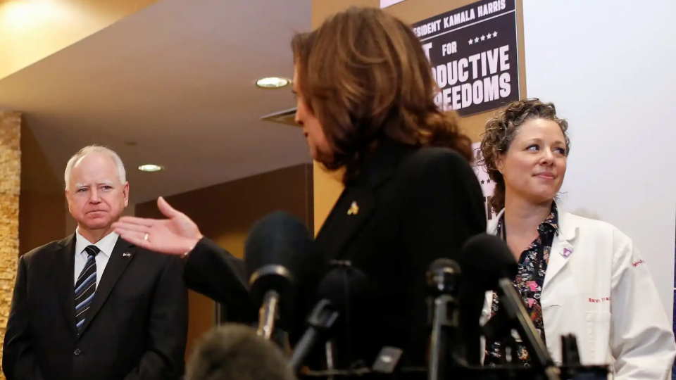 Kamala Harris speaks next to Minnesota Governor Tim Walz during a visit to the St. Paul Health Center