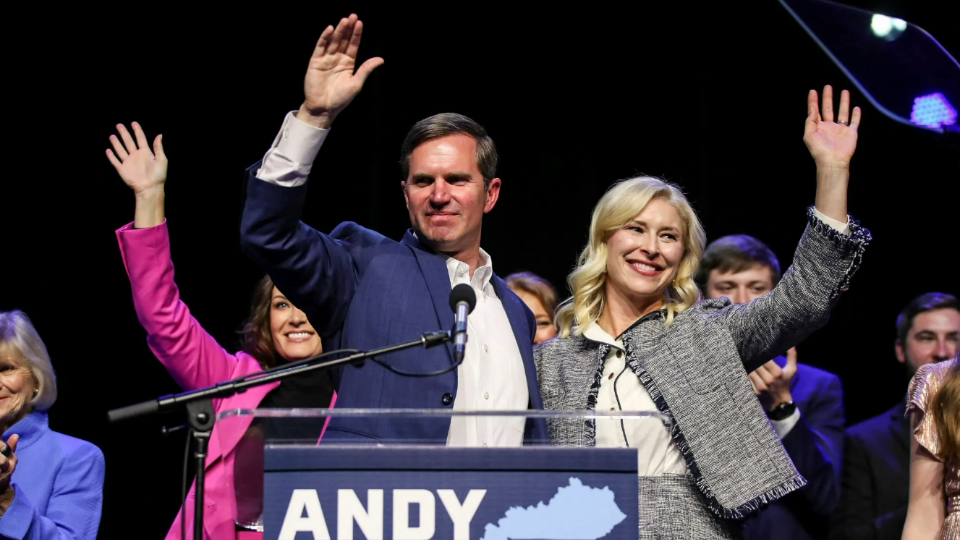 Kentucky Governor Andy Beshear waves with his wife Britainy Beshear and Lt. Gov. Jacqueline Coleman after winning a second term