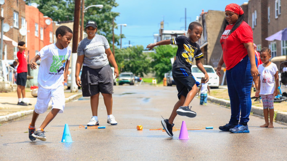 Kids participate in a playful learning activity outside.