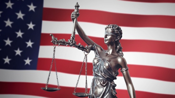 Lady justice with USA flag in background