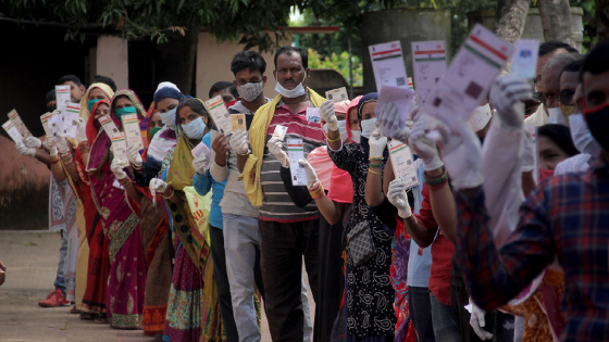 Local village voters are seen in the queue with the proper Covid-19 guidelines as they wait to cast their votes