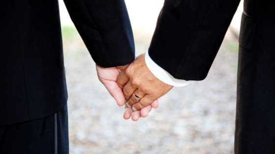 Male couple holding hands