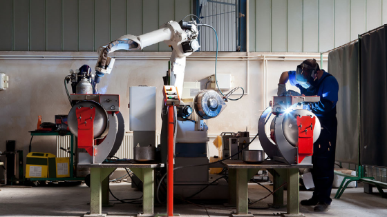 Man and robotic machine work together