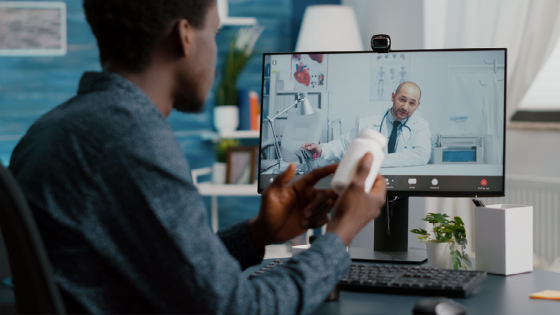 Man at home seeking medical help from doctor via online intenet telehealth consultation with family doctor