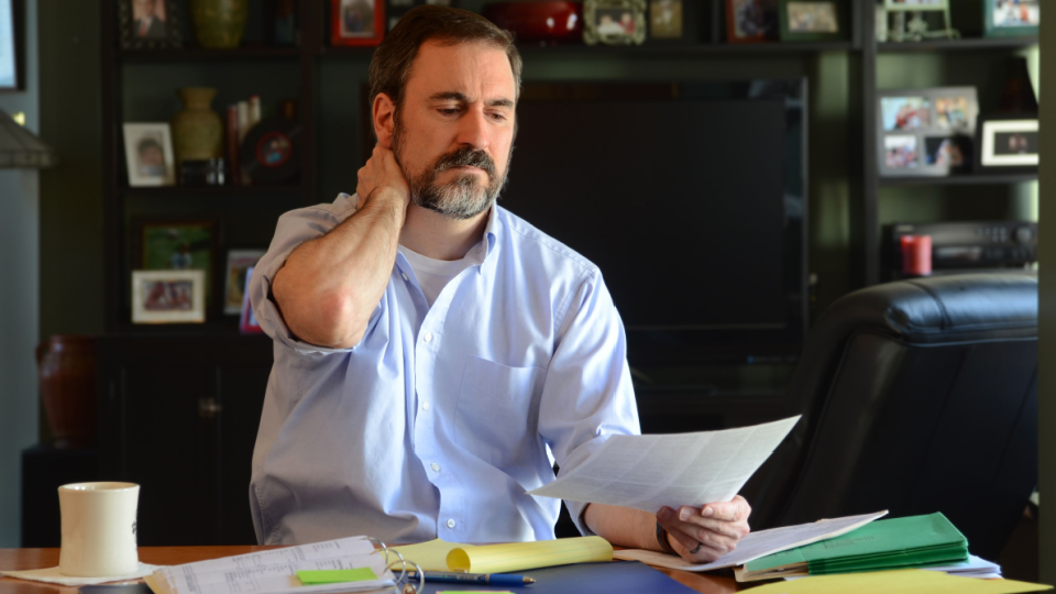 Man sits at home working on his taxes.