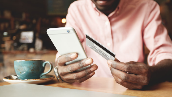 Man uses credit card to make order on his phone