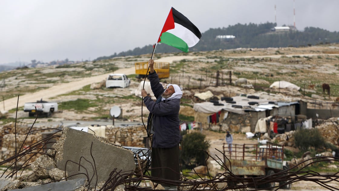 Man waving Palestinian flag