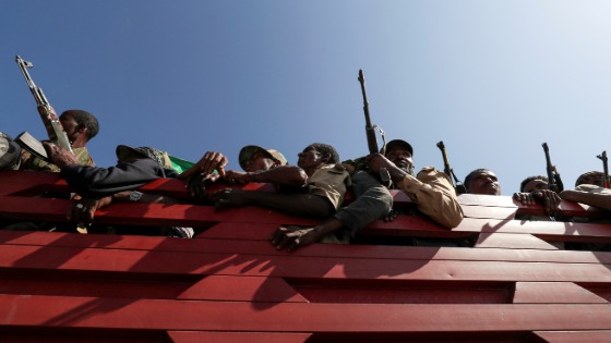 Members of Amhara region militias ride on their truck