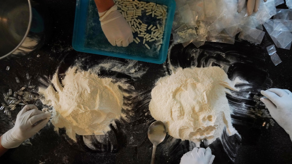 Members of the Sinaloa Cartel prepare capsules with methamphetamine in a safe house in Culiacan, Mexico.