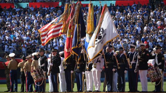 Members of the military present the flag during the national anthem before the game between the American League and the National League at Dodger Stadium