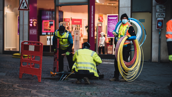 Men setting up broadband cables