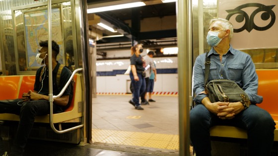 Men sitting on public transit during the pandemic