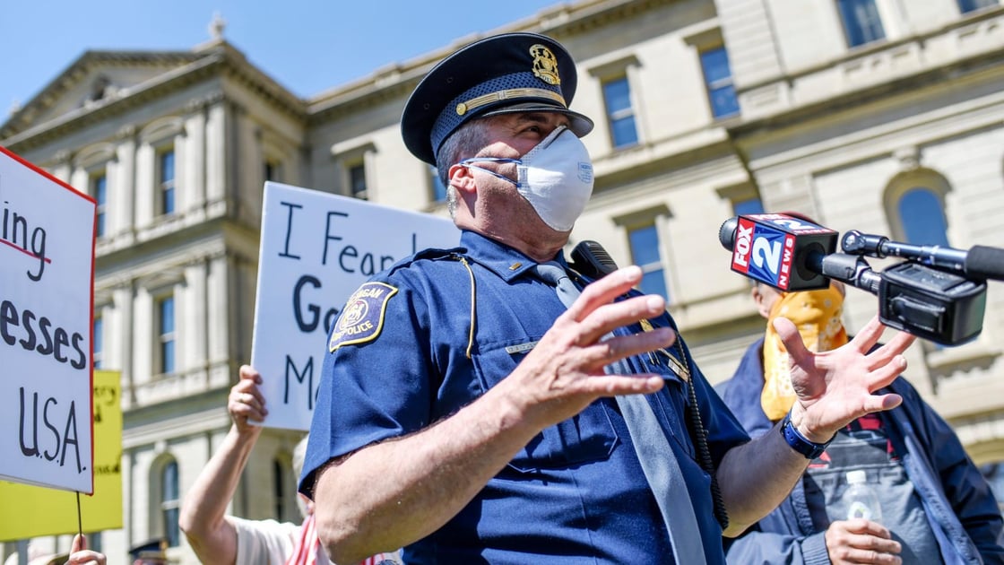 Michigan State Police Lt. Brian Oleksyk talks to reporters during the Operation Haircut protest