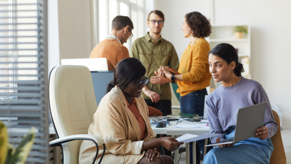 A group of workers collaborate in office